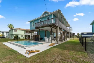 Dive into the sparkling private pool , surrounded by a paved deck perfect for sunbathing. Adjacent to the pool is a covered patio area with seating and a BBQ grill , making it the perfect spot for relaxing and enjoying the outdoors.