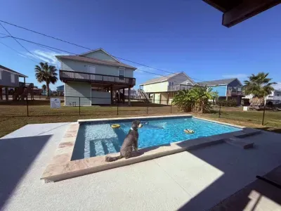 Dive into the sparkling private pool , surrounded by a paved deck perfect for sunbathing. Adjacent to the pool is a covered patio area with seating and a BBQ grill , making it the perfect spot for relaxing and enjoying the outdoors.