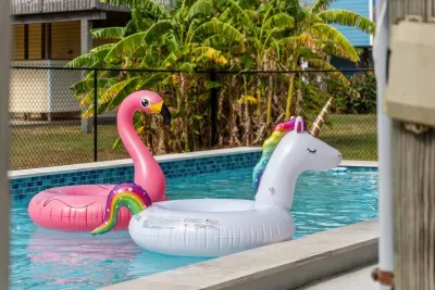 Dive into the sparkling private pool , surrounded by a paved deck perfect for sunbathing. Adjacent to the pool is a covered patio area with seating and a BBQ grill , making it the perfect spot for relaxing and enjoying the outdoors.