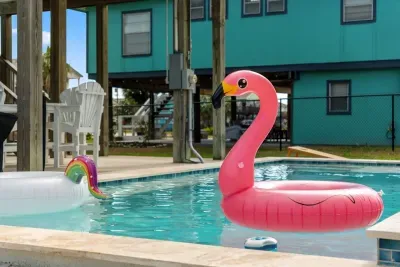 Dive into the sparkling private pool , surrounded by a paved deck perfect for sunbathing. Adjacent to the pool is a covered patio area with seating and a BBQ grill , making it the perfect spot for relaxing and enjoying the outdoors.