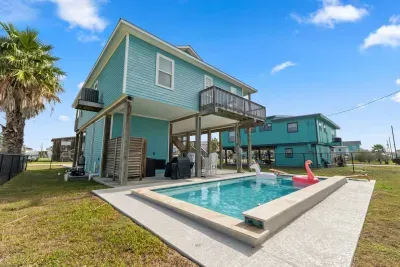 Dive into the sparkling private pool , surrounded by a paved deck perfect for sunbathing. Adjacent to the pool is a covered patio area with seating and a BBQ grill , making it the perfect spot for relaxing and enjoying the outdoors.