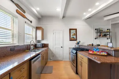 Whip up your favorite meals in this fully equipped kitchen, featuring modern appliances, ample counter space, and a central island perfect for cooking, gathering, or casual dining. 
