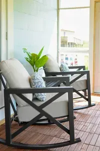 This cozy glass-walled balcony offers the perfect spot to sip your morning coffee or unwind at sunset, surrounded by peaceful views of the yard and young fruit trees, with easy access to both the living room and front balcony.