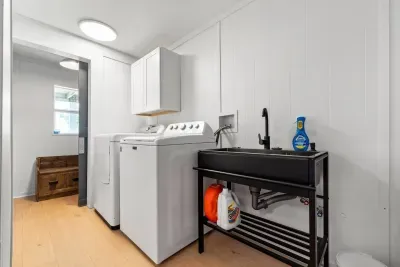 The spacious laundry area not only makes chores easy but also opens to a cozy secret room with a TV, a perfect hideaway that kids will absolutely love.
