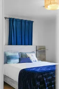 Soft light fills this peaceful bedroom, where a cozy bed and simple comforts create a restful space to unwind.