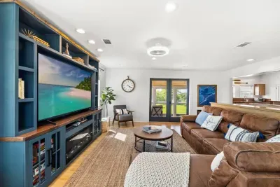 Kick back on the spacious leather couch, catch your favorite shows on the Smart TV, and unwind with sunlight streaming through the surrounding windows.