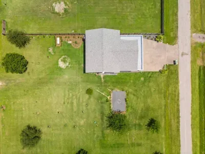 An overhead view of Captain’s Quarter, spacious yard and a growing orchard ready for future harvests.