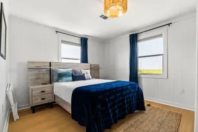 Soft light fills this peaceful bedroom, where a cozy bed and simple comforts create a restful space to unwind.