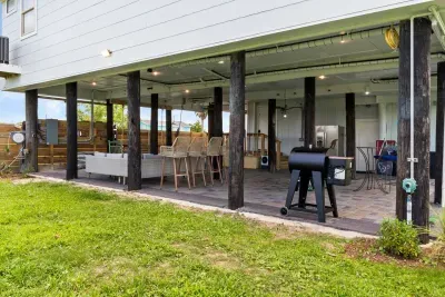 Unwind in comfort beneath the house, shaded, breezy, and perfect for relaxing after a day at the beach.