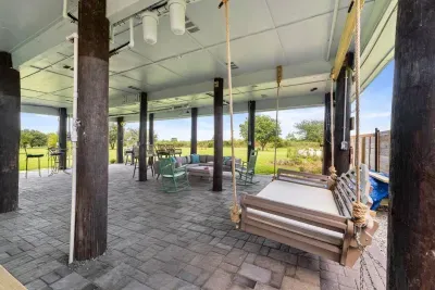 Unwind in comfort beneath the house, shaded, breezy, and perfect for relaxing after a day at the beach.