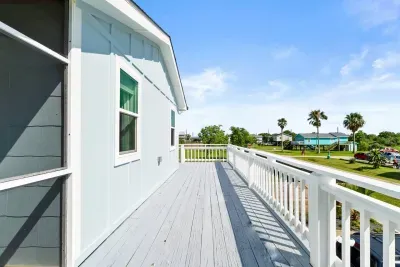 Take in the peaceful view from the balcony, the quiet road that leads to the beach, just a short stroll away.