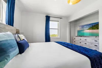 Soft light fills this peaceful bedroom, where a cozy bed and simple comforts create a restful space to unwind.