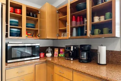 Whip up your favorite meals in this fully equipped kitchen, featuring modern appliances, ample counter space, and a central island perfect for cooking, gathering, or casual dining. 