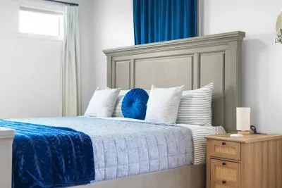 Soft light fills this peaceful bedroom, where a cozy bed and simple comforts create a restful space to unwind.