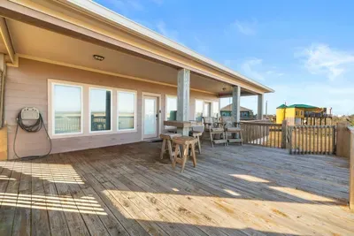 Spacious wraparound deck with plenty of seating and coastal views—perfect for morning coffee, sunset drinks, and relaxing in the sea breeze.