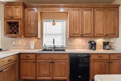 Bright, well-stocked kitchen with plenty of cabinet space, a double sink, dishwasher, and coffee station—everything you need to cook, clean up, and start your day with a fresh cup of coffee.