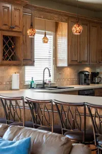 Beautiful kitchen with a large island, warm pendant lighting, and plenty of seating—perfect for gathering with family, sharing meals, and enjoying coffee while you cook.