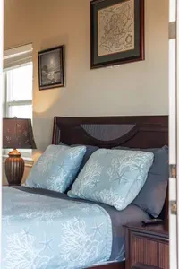 Sleep easy in a comfy bedroom with coastal décor, soft bedding, and a relaxing vibe for the perfect getaway.