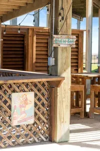 Your own private “Beach Bar” setup under the house with string lights and seating—perfect for mixing drinks, hanging out, and enjoying the coastal vibes.