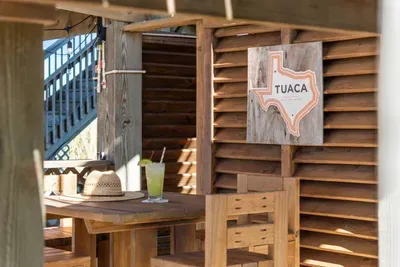 Kick back at the beach bar and enjoy your own laid-back hangout spot under the house—perfect for drinks, laughs, and relaxing after a day in the sun.