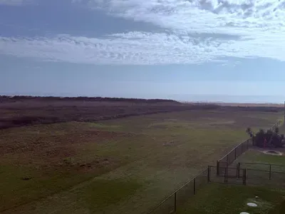 Unwind with wide-open coastal views and a glimpse of the Gulf—quiet dunes, fresh sea air, and plenty of space to relax just minutes from the beach.