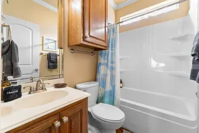 Clean, functional bathroom with a spacious vanity and a shower/tub combo—perfect for quick rinses, bath time, and getting ready with ease.