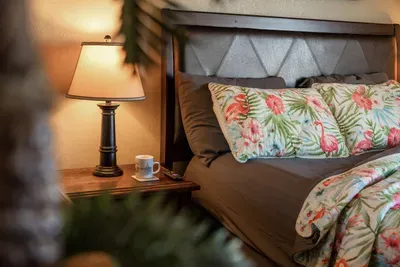 Cozy bedroom details with soft linens, warm bedside lighting, and a relaxing coastal vibe—perfect for winding down and getting a great night’s sleep.