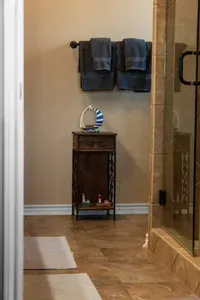 Clean, spacious bathroom with fresh towels and a large walk-in shower—perfect for rinsing off and getting ready with ease.