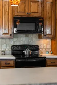 Fully equipped kitchen with a full-size stove/oven and built-in microwave—perfect for cooking everything from quick breakfasts to family dinners during your stay.