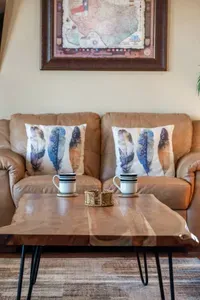 Start your morning in this cozy lounge space with a comfy leather sofa, beachy accent pillows, and a rustic coffee table—perfect for sipping coffee and relaxing after a day in the sun.