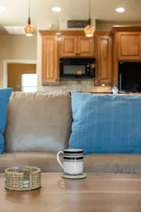 Cozy, beach-inspired living room with comfy seating and a relaxing vibe—perfect for enjoying your morning coffee while staying connected to the open kitchen and dining space.