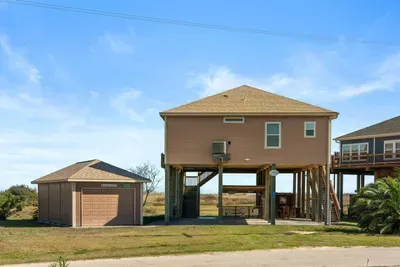 Private coastal home with a detached garage, elevated deck living, and wide-open views—plenty of space to park, spread out, and enjoy the beach breeze.