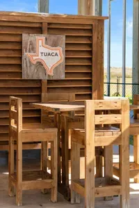 Enjoy drinks and conversation at the outdoor bar seating area—perfect for relaxing in the shade and soaking up those laid-back beach vibes.