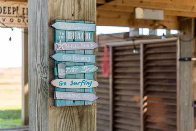 Little beach vibes everywhere—kick back under the string lights and follow the signs to your next adventure! ️