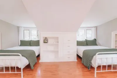 A retreat of its own. The secluded upstairs bedroom features two queen beds, a dedicated work space, and is where you will find the delightful sunroom. There is built in shelving and closet space for guests to utilize.