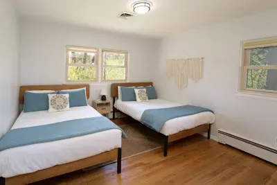 The third bedroom has two comfy double beds. This room also offers a fun play space for younger guests. You will find a cube shelf of toys and books in the closet, built in drawers, sound machine, extra blankets, and a portable crib available. 