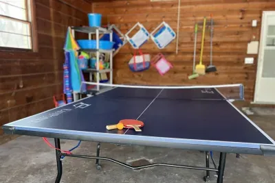 GAME ON! In the garage you will find a ping pong table, corn hole, and a bocce ball set. A place for endless fun in the garage or the backyard space! 