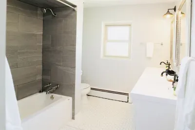 In the main bathroom, you'll find a double vanity with plenty of cupboard and drawer space, a shower/tub combo, a sink, and a toilet. Fresh white towels, washcloths, hand towels, and makeup towels are all provided for your convenience.