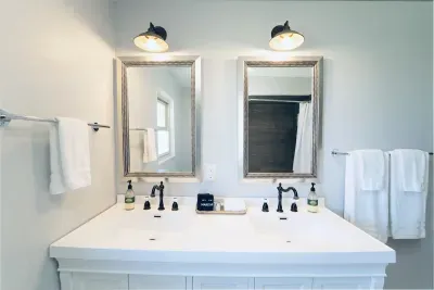In the main bathroom, you'll find a double vanity with plenty of cupboard and drawer space, a shower/tub combo, a sink, and a toilet. Fresh white towels, washcloths, hand towels, and makeup towels are all provided for your convenience.
