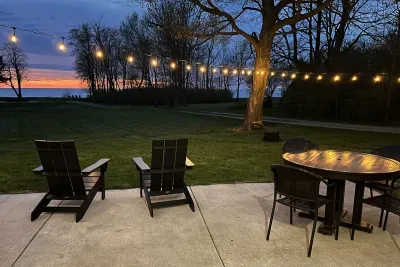 Experience the patio and backyard with Lake Michigan's sparkling blue water as your backdrop. The house and patio sit approximately 150 yards off of the bluff. On the patio you will have access to a Weber grill, year-round hot tub, and ample seating. 