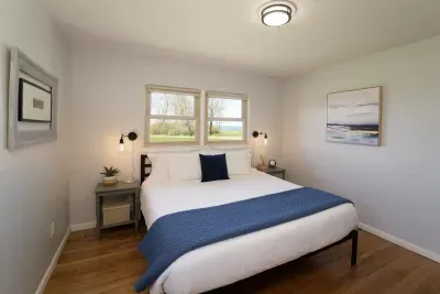 Enjoy some well-deserved rest and relaxation during your vacation! The primary bedroom, complete with a comfy king-size bed and views of Lake Michigan, offers the perfect space for a peaceful night's sleep and rejuvenating rest!