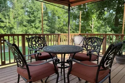 Surrounded by a tranquil atmosphere and vibrant greenery, the bistro-style table invites you to savor every moment on the deck, making you feel pampered and relaxed.