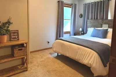 Get comfortable in this queen bedroom located on the main floor.  This room is complete with a closet, a stackable washer/dryer, and laundry essentials for added convenience. 