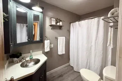 Wash away the sand! After a fun day at the beach this bathroom located on the main floor offers a shower/tub, sink, vanity, cabinet storage, a toilet, and shampoo, conditioner, and body wash. 