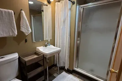 The lower level bathroom offers a shower, sink, mirror, toilet, and shampoo, conditioner, and body wash. Adding extra convenience for the guests that are sleeping in the lower level bedrooms. 