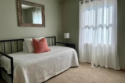 This cute and cozy daybed with a twin size trundle underneath is located on the main floor. The bedroom offers a nice size closet and some toys tastefully stored for our younger guests. 