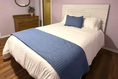 Good night, sleep tight! This bedroom on the lower level is fit with a queen size bed, dresser, and mirror. A third full bathroom is located directly off of this bedroom. 