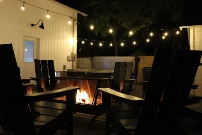 Get cozy around the campfire in the backyard. Complete with Edison lights for a magical feel. 