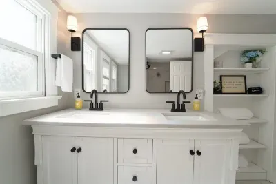 The bathroom on the upper level is located between the two bedrooms upstairs. It offers a double vanity for your convenience.  