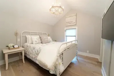 Turn in for the night in this comfy queen size bed. The primary bedroom is located upstairs. It offers a smart TV, fan, and ample closet space for storing your belongings.  